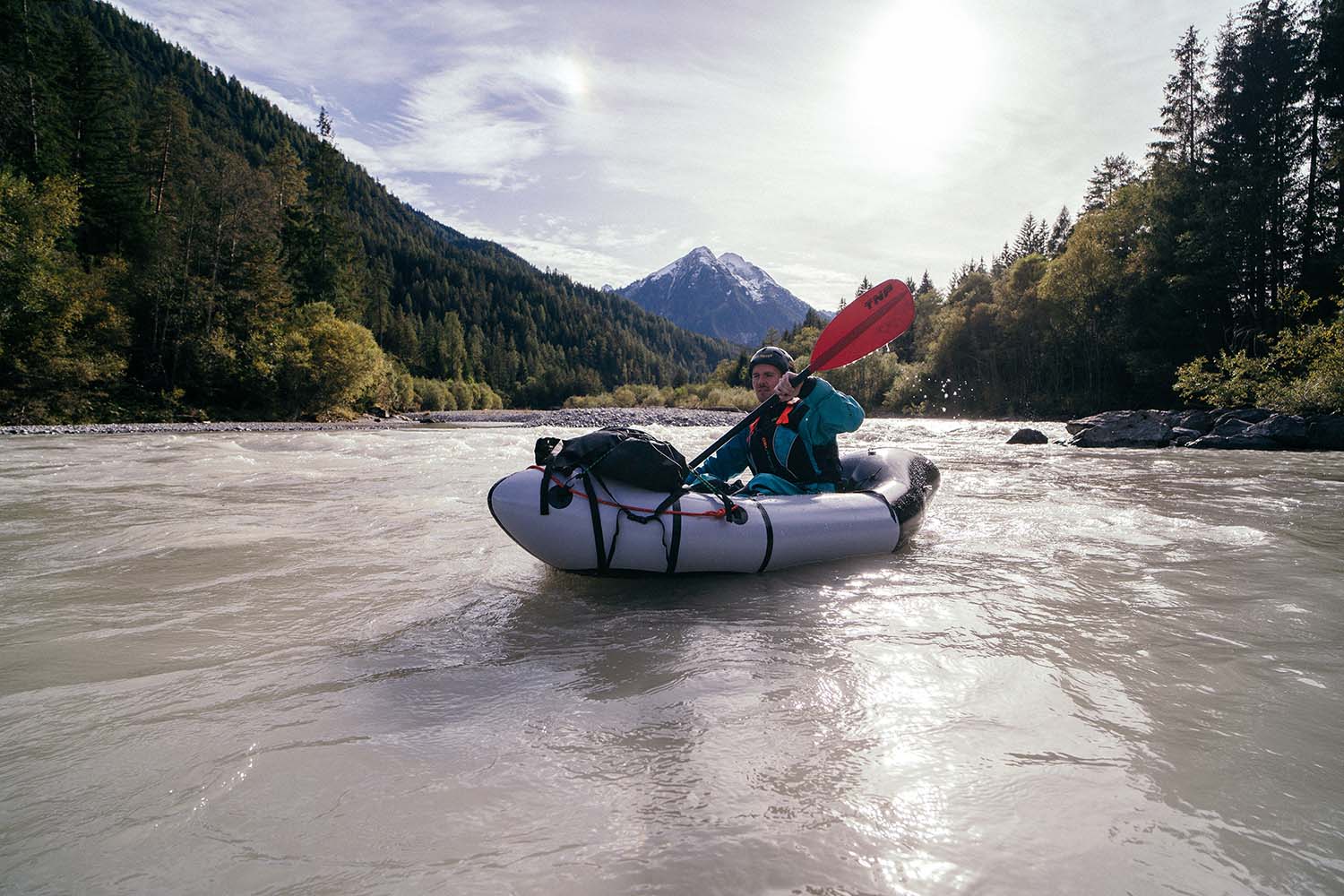 Packrafting on the calm waters of the Lech River in Austria during a scenic trail adventure